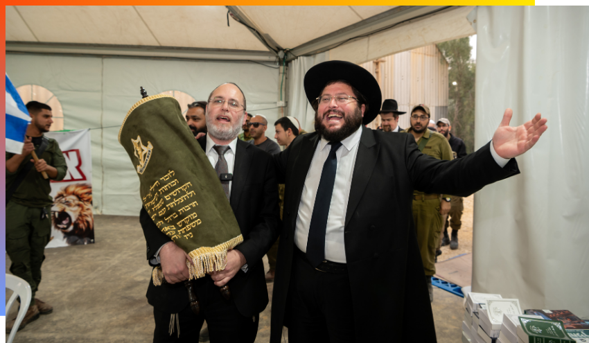 Aish staff dancing with a Sefer Torah