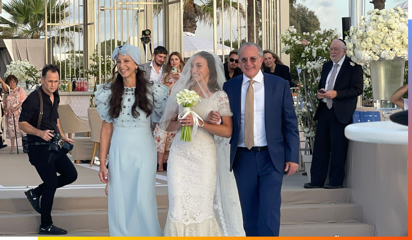 Louis and Manette Mayberg walking their daughter Yacova to the chuppah.