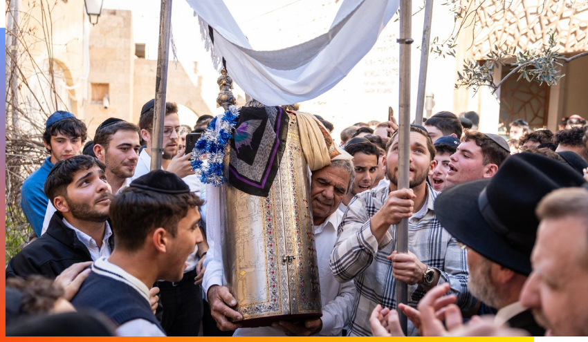 Yeshiva students welcome the arrival of a newly completed Sefer Torah.