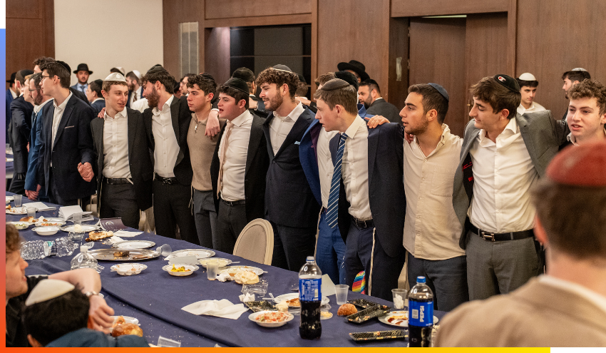 Aish students sing together during a post-Shabbos meal in Jerusalem.