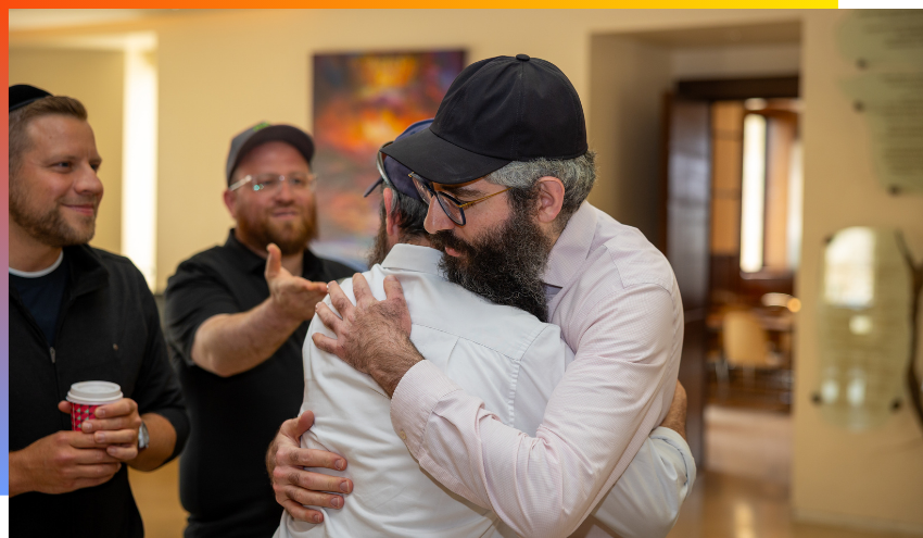 Rabbi Dov Ber Dohen embraces a member of the Daily Giving Delegation that came to study at Aish this past week.