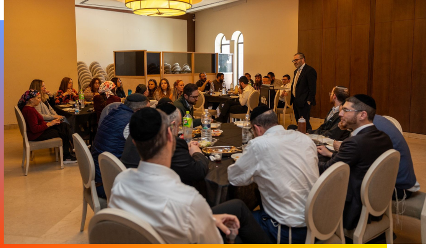 Aish staff at a Town Hall meeting with Rabbi Steven Burg in the Goldman Hall at the Dan Family Aish World Center.