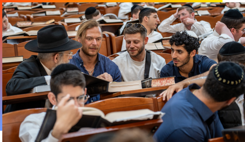 Aish students studying with Israeli students during a recent trip to a large Beit Midrash.