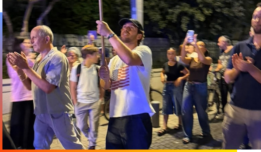 Omer holding a flag during the celebratory procession