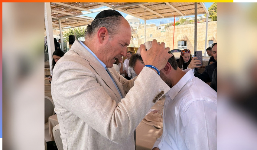 Ambassador Ezra Cohen giving a priestly blessing to Ben Chassin